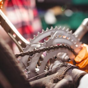 Close-up of mechanic repairing a bicycle in workshop