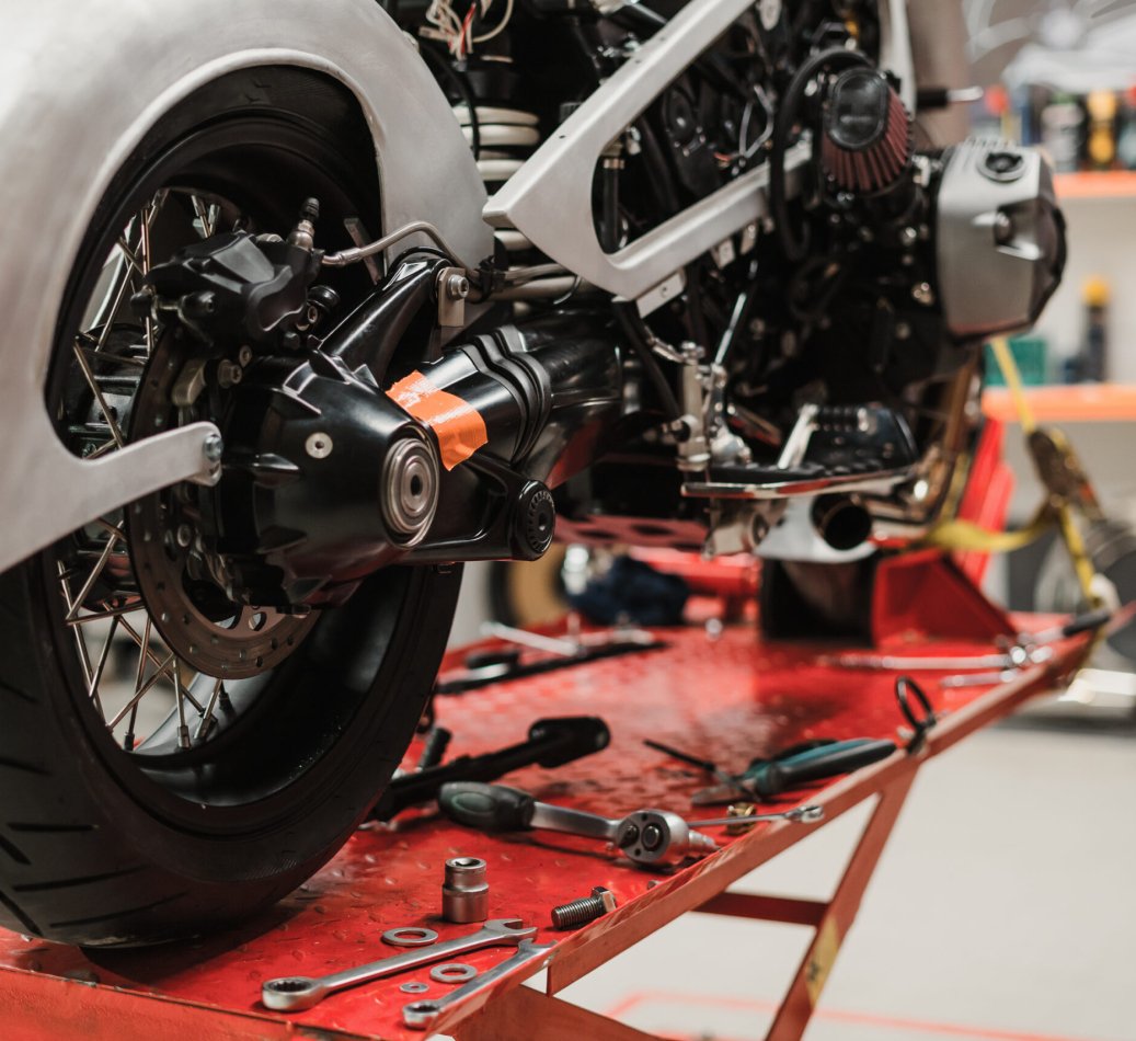 Fixing Custom motorcycle standing in repair shop. Instruments and equipment. Hobbies and unique Jobs